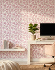 Blush Tropics pink botanical peel and stick wallpaper creating ambiance in a serene bathroom