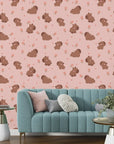 Illustrated brown capybaras and blooming pink petals decorate this easy-apply peel and stick wallpaper - Blush Blooms