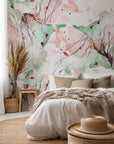 A watercolor wall covering featuring abstract splotches of pink and green hues, titled Blush Thicket