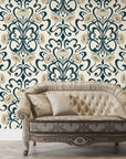 Teal and gold Blushed Fern Fantasy damask wallpaper behind tufted vintage settee in elegant room