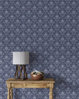Navy and silver damask Blushed Whisper wallpaper with ornate floral medallions in styled living room