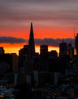 Dramatic Burning Horizon wallpaper featuring San Francisco skyline silhouette against vibrant orange and purple sunset sky