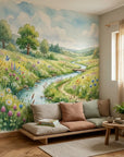 Watercolor meadow mural with winding stream, wildflowers, and trees on living room accent wall
