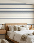 Calm Weave navy blue diagonal stripe wallpaper adding character to a cozy bedroom