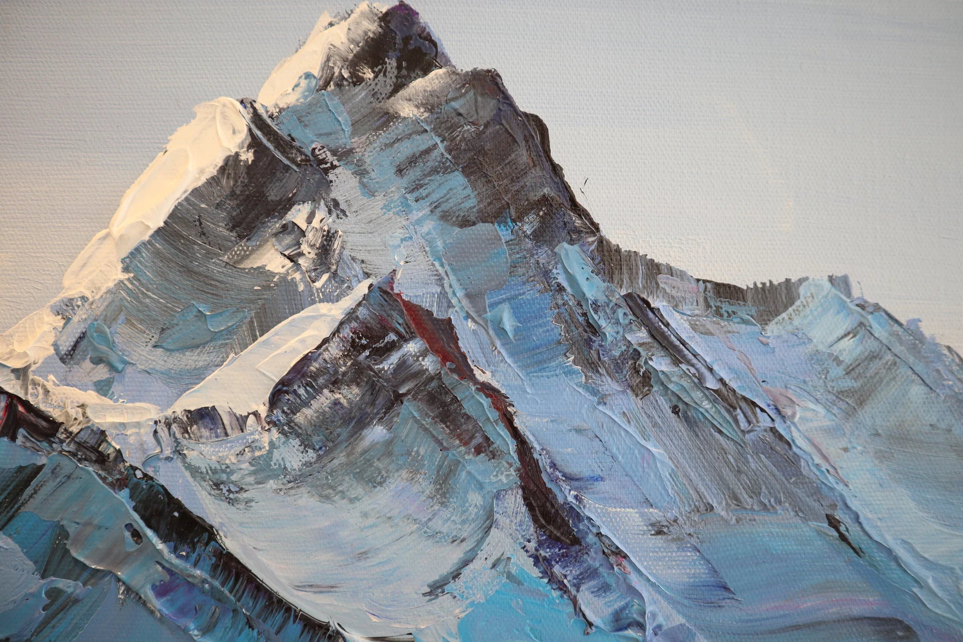 Carved in Ice blue mountain impasto landscape wallpaper creating ambiance in a serene bathroom
