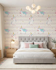 Celestial Prance pink and gold unicorn wallpaper adding character to a cozy bedroom