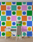 Vibrant checkered self-adhesive wall covering adorned with cheerful grinning icons in a non-reflective finish. - Cheery Checks