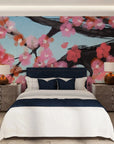 Pink cherry blossoms and dark branches on blue sky removable wallpaper in modern bedroom