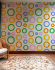 Multi-hued, chromatic wallpaper featuring an echoing, layered design