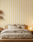 Citrine Column yellow striped peel and stick wallpaper adding character to a cozy bedroom