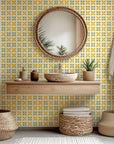 A tiled, geometric pattern wallpaper featuring bright yellow lemons and dark green foliage.