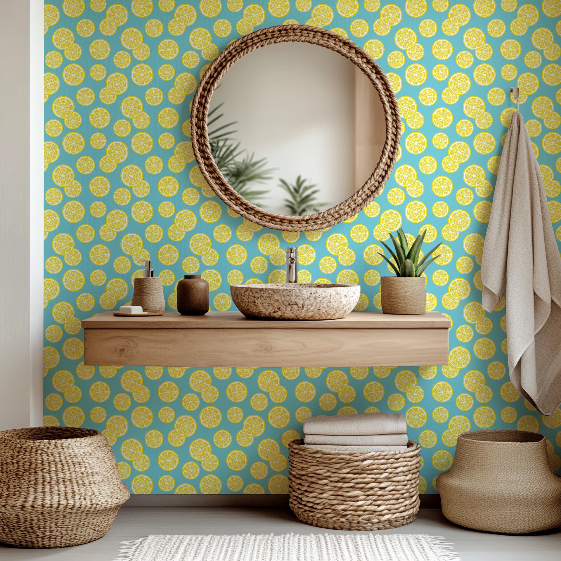 Green foliage and sunny yellow lemons are pictured trailing diagonally over a plain white surface.