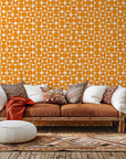 Self-adhesive wallpaper featuring a mid-century modern, orange semicircle geometric pattern, known as Citrus Grid.
