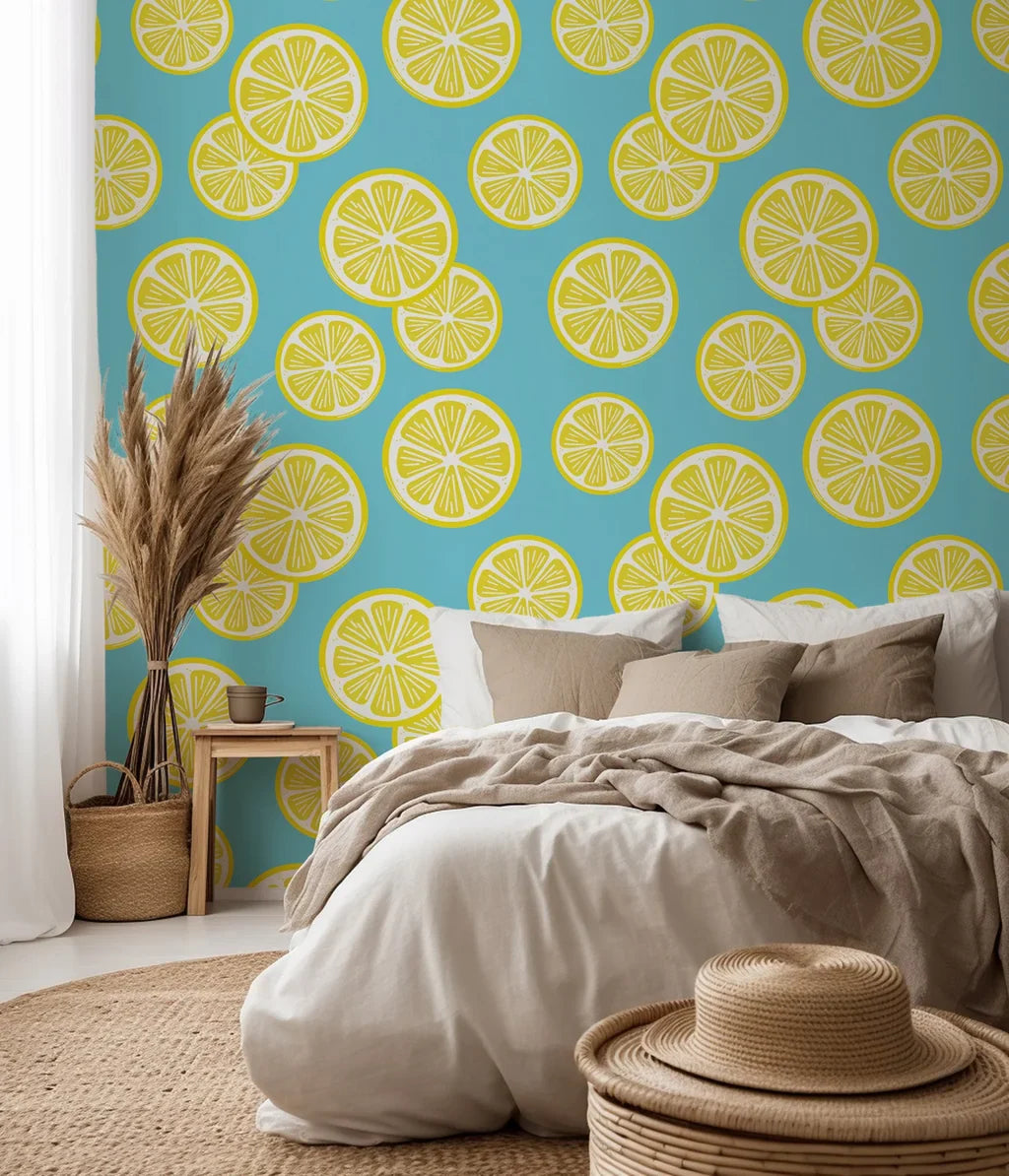 Vivid yellow lemons and verdant foliage flow over a white surface.