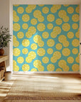 Sunny yellow lemons and accompanying greenery wind across a pure white canvas.