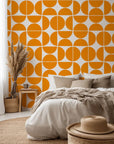 Self-adhesive wallpaper featuring an orange, mid-century geometric half-circle pattern, known as Citrus Grid.