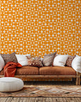 Self-adhesive wallpaper featuring a mid-century modern, orange semicircle geometric pattern, known as Citrus Grid.