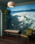 Misty clouds surrounding terrain creating contemplative scene removable wall mural