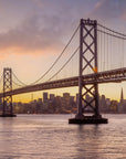 Copper Crossing wallpaper featuring San Francisco Bay Bridge at golden hour with purple and amber sky tones