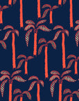 Deep blue wallpaper adorned with vibrant coral palm trees. Tropical 'Coral Sway' design