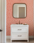 Coral geometric wallpaper with hand-drawn line patterns forming a soft, symmetrical abstract design.