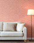 Coral geometric wallpaper with hand-drawn line patterns forming a soft, symmetrical abstract design.