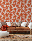 A stylized botanical wall covering, featuring sheer orange and coral foliage. Product: Coral Whispers
