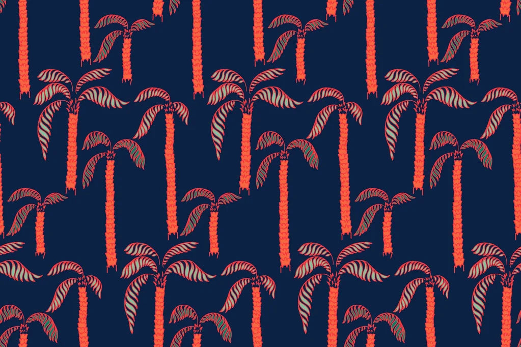 Deep blue wallpaper adorned with vibrant coral palm trees. Tropical 'Coral Sway' design