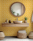 Whimsical wallcovering in mustard yellow featuring a cream hand-drawn floral motif (Cosmic Bloom)