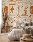 Western icon wallpaper featuring cowboy boots, horseshoes, moons, snakes, and desert motifs in warm clay tones.