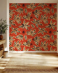 Abstract black floral sketches on a vibrant rust orange peel and stick wallpaper