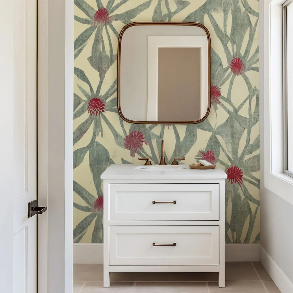 Muted green foliage and soft red floral centers form an organic pattern on this botanical wallpaper, rendered in a hand-painted style on a warm cream surface