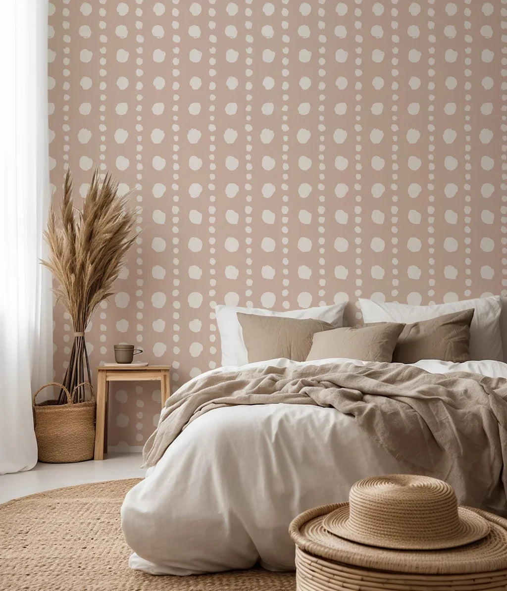 A dotted wall treatment showcasing soft, off-white, manually painted circles set against a neutral, sandy-toned base