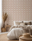 A dotted wall treatment showcasing soft, off-white, manually painted circles set against a neutral, sandy-toned base