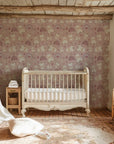 Self-adhesive matte wallpaper for a baby's room showcasing illustrated lambs and colorful rainbows on a dusty mauve background - Dream Fields