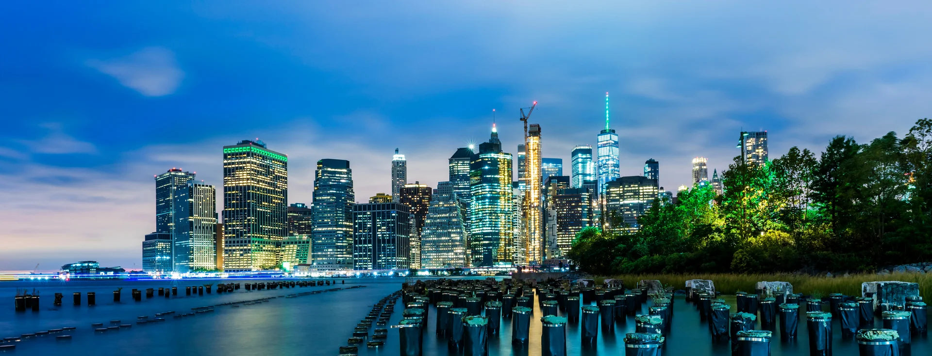 Modern Driftwood & Dreams wallpaper featuring illuminated city skyline at dusk with waterfront pilings