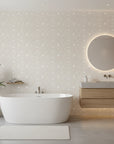 Dune Ribbon sandstone swirling line wallpaper creating ambiance in a serene bathroom