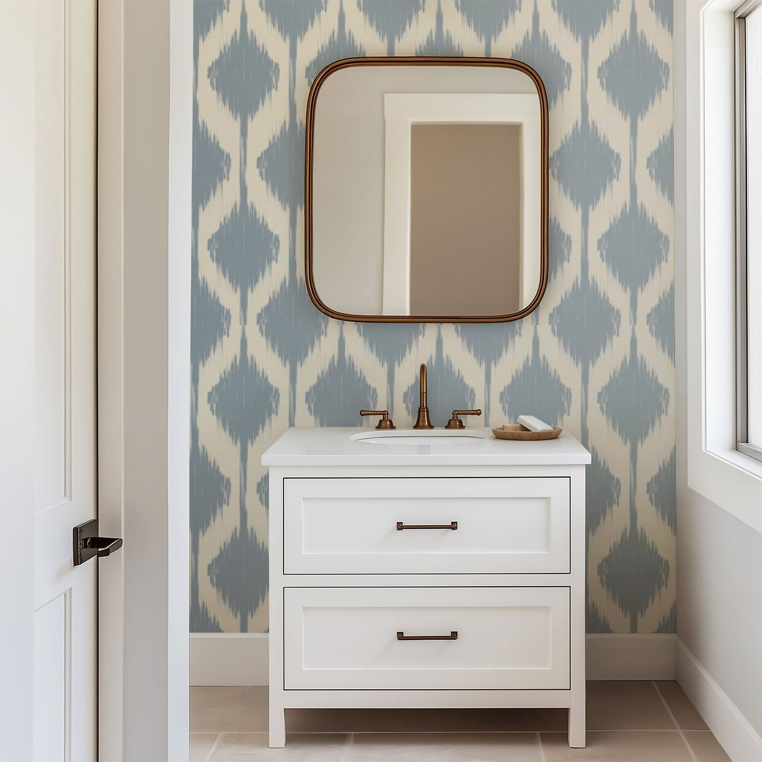 Soft blue ikat wallpaper with blurred diamond shapes in a repeating pattern on a warm off white background.