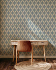 A traditional ikat textile-inspired wallpaper showing fuzzy blue diamond patterns continuously printed upon a creamy white background