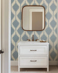 Wallpaper featuring a pattern of soft blue, hazy diamonds that repeat across a warm, off-white base color