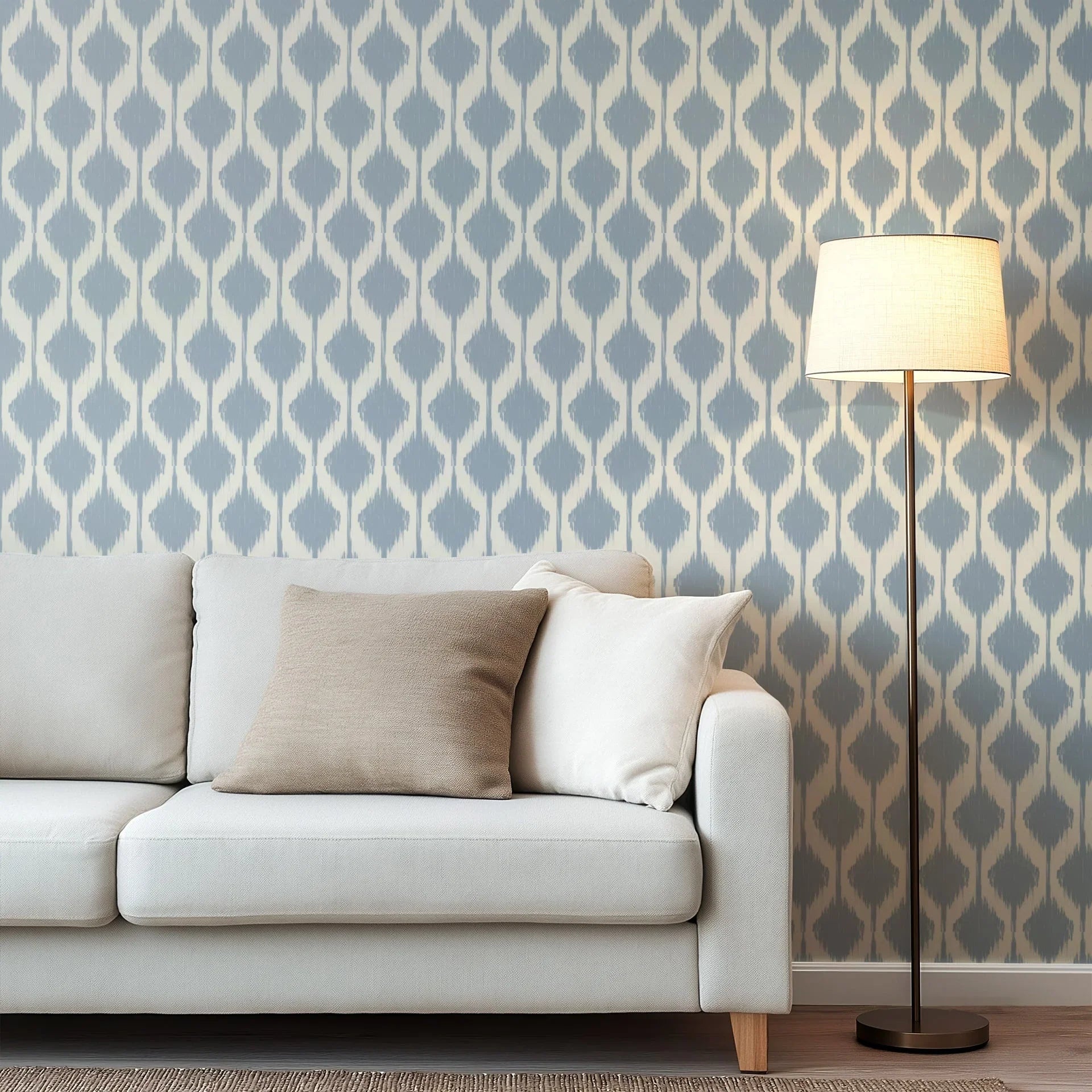 The gentle azure ikat wallpaper exhibits a recurring motif of diffuse lozenge shapes against a backdrop of pale ecru.