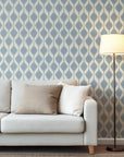 The gentle azure ikat wallpaper exhibits a recurring motif of diffuse lozenge shapes against a backdrop of pale ecru.