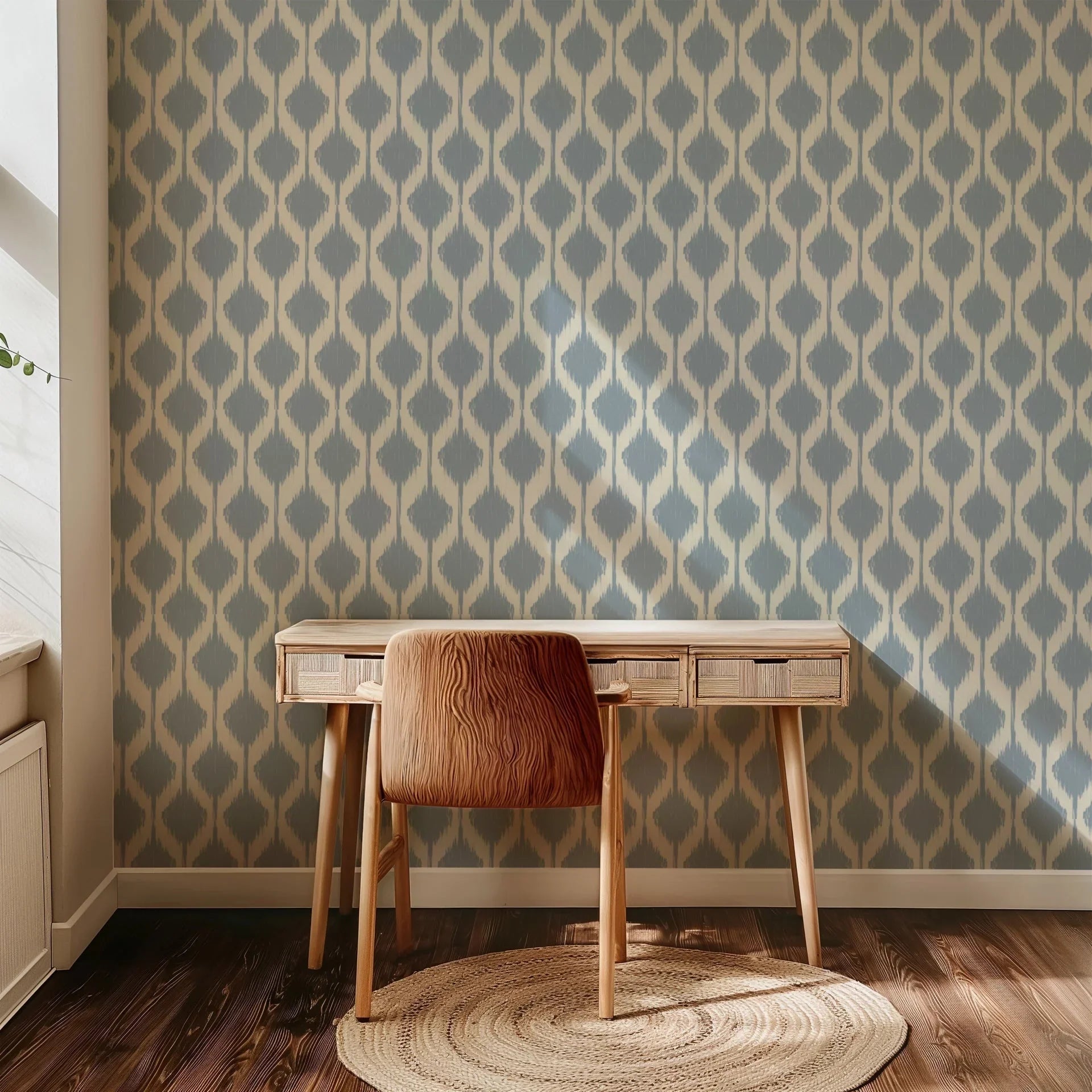 A traditional ikat textile-inspired wallpaper showing fuzzy blue diamond patterns continuously printed upon a creamy white background