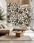 Black floral branches adorn a contemporary, self-adhesive cream wall covering, pattern name Ebony Bloom