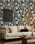 Ebony Garden black and cream floral silhouette wallpaper in a warm and inviting living room