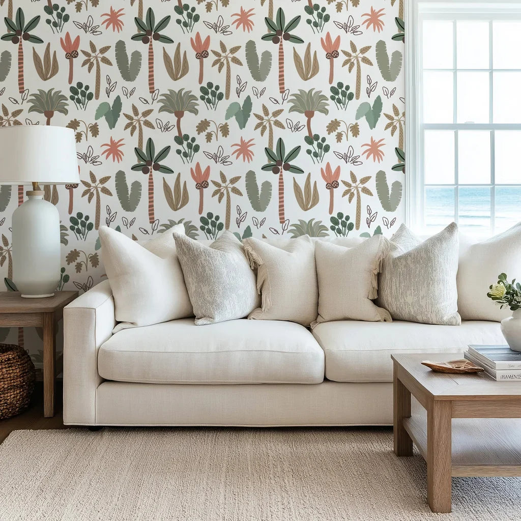Boho nursery wall covering with pastel green and pink palm leaf designs.