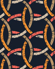 A worn-look wall covering featuring an interlocking geometric design in deep blue and amber tones from Ember Threads