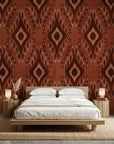 Ember Wings rust brown tribal ikat geometric wallpaper adding character to a cozy bedroom