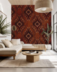 Self-adhesive wallpaper featuring a traditional geometric Ikat pattern in beige and rust brown, titled 'Ember Wings'