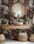 Peel and stick wallpaper featuring a moody botanical design with rust and grey fern fronds on a dark backdrop
